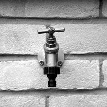 Water faucet on a brick wall.