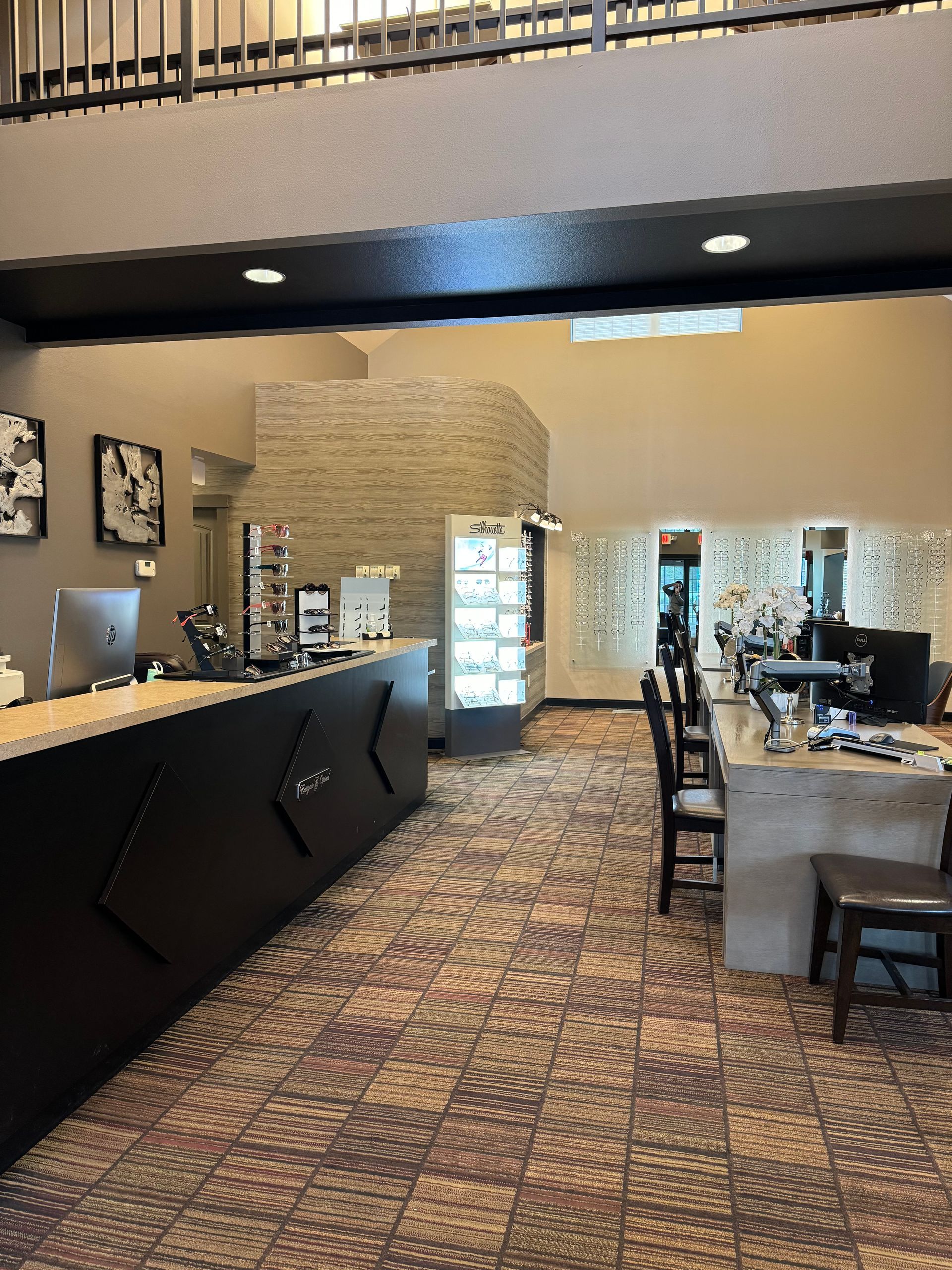 A woman is kneeling down in front of a fire pit.