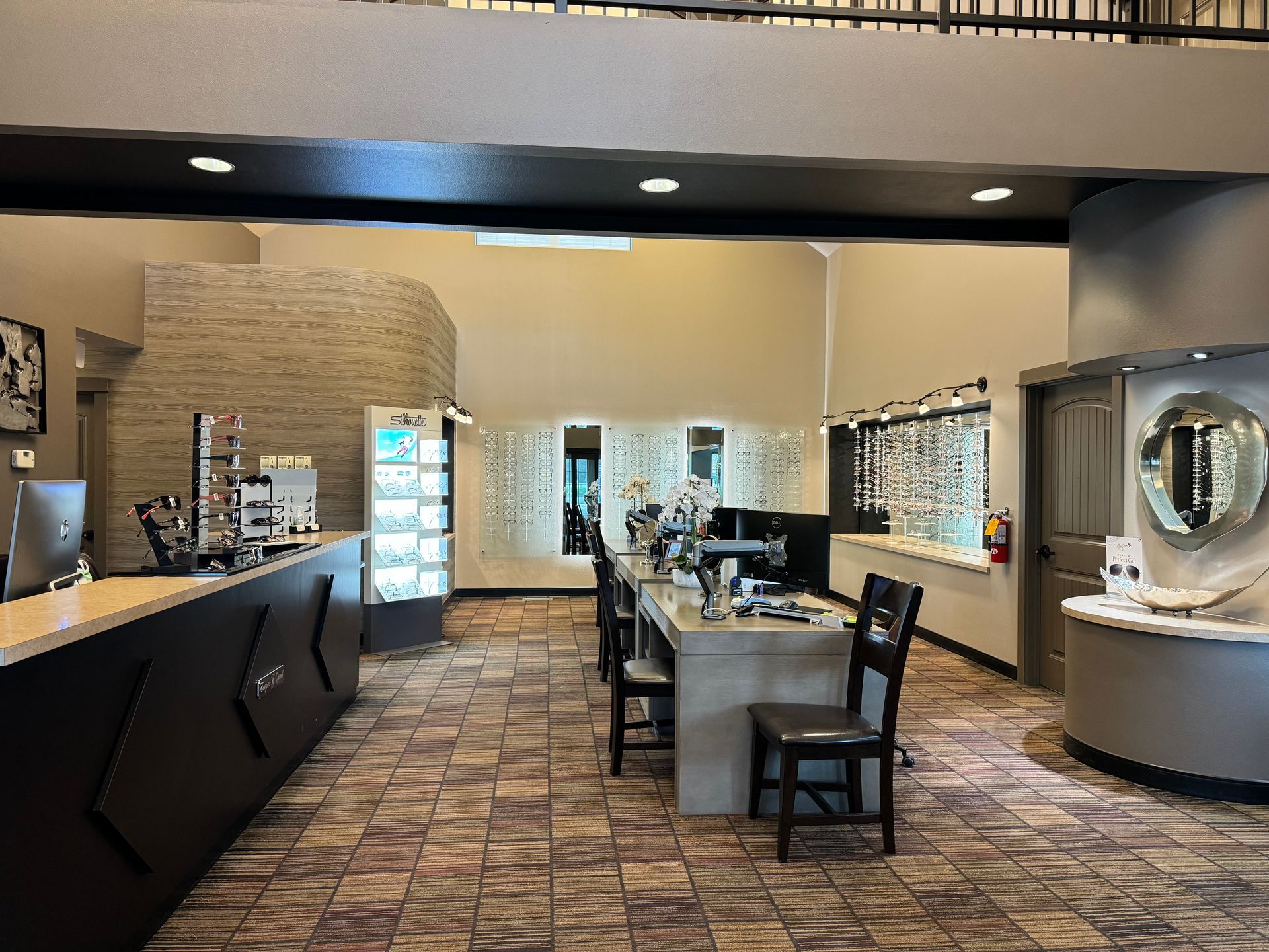 A woman is standing next to a woman sitting in front of a machine.