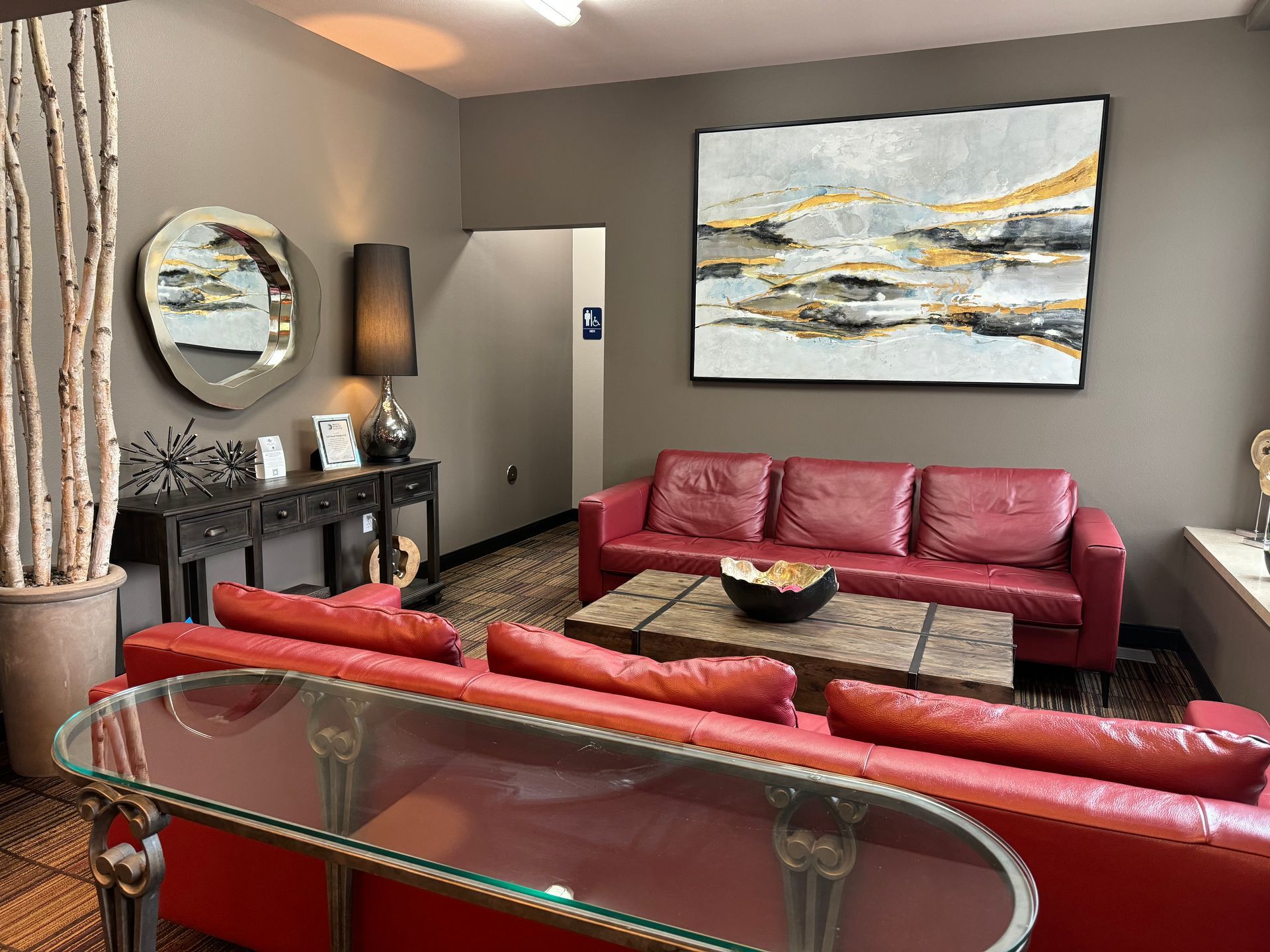 A group of people are standing around a table in a room.