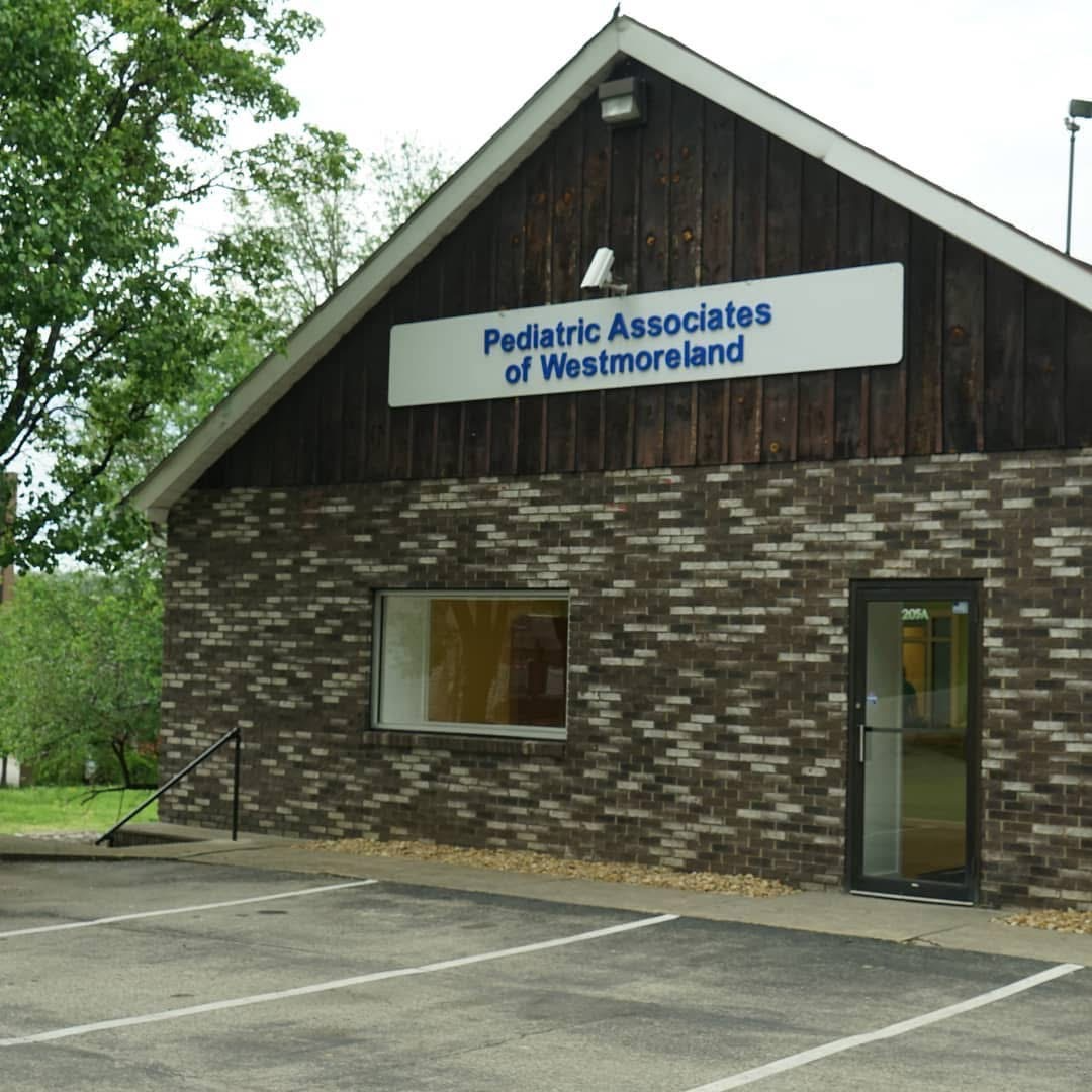A brick building with a sign that says pediatric associates of westmoreland