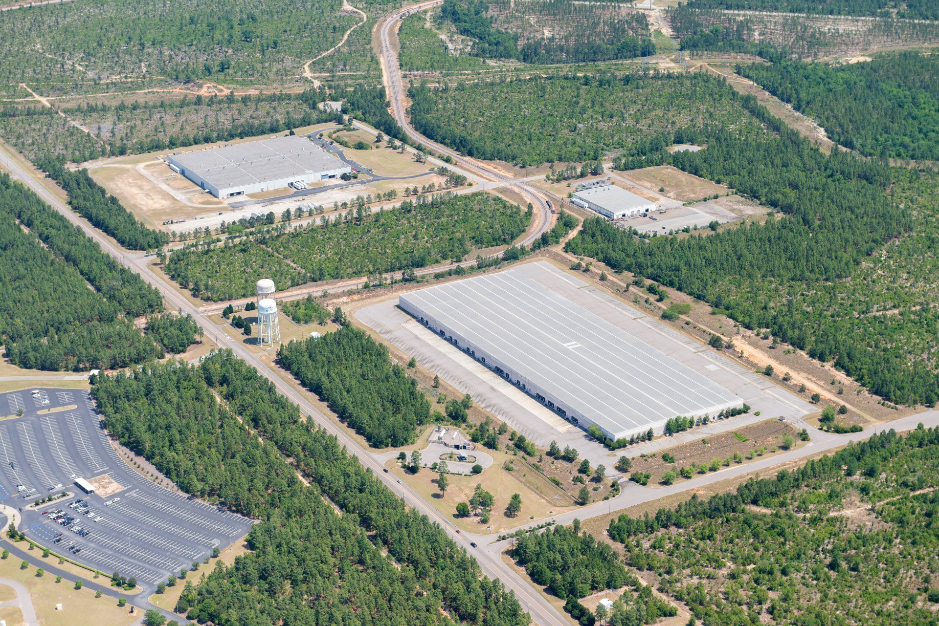 An aerial view of a large industrial area surrounded by trees