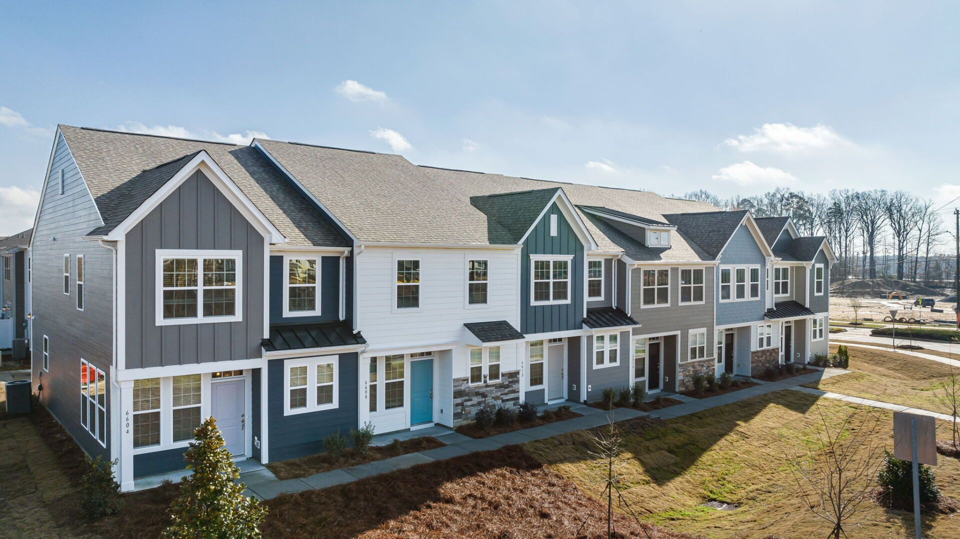 An aerial view of a row of houses on a sunny day.