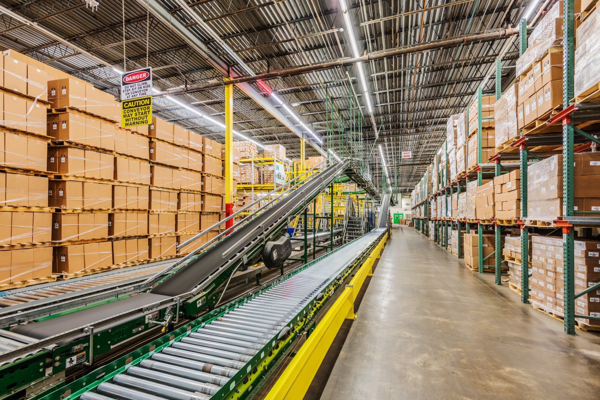 A warehouse filled with lots of boxes and a conveyor belt.