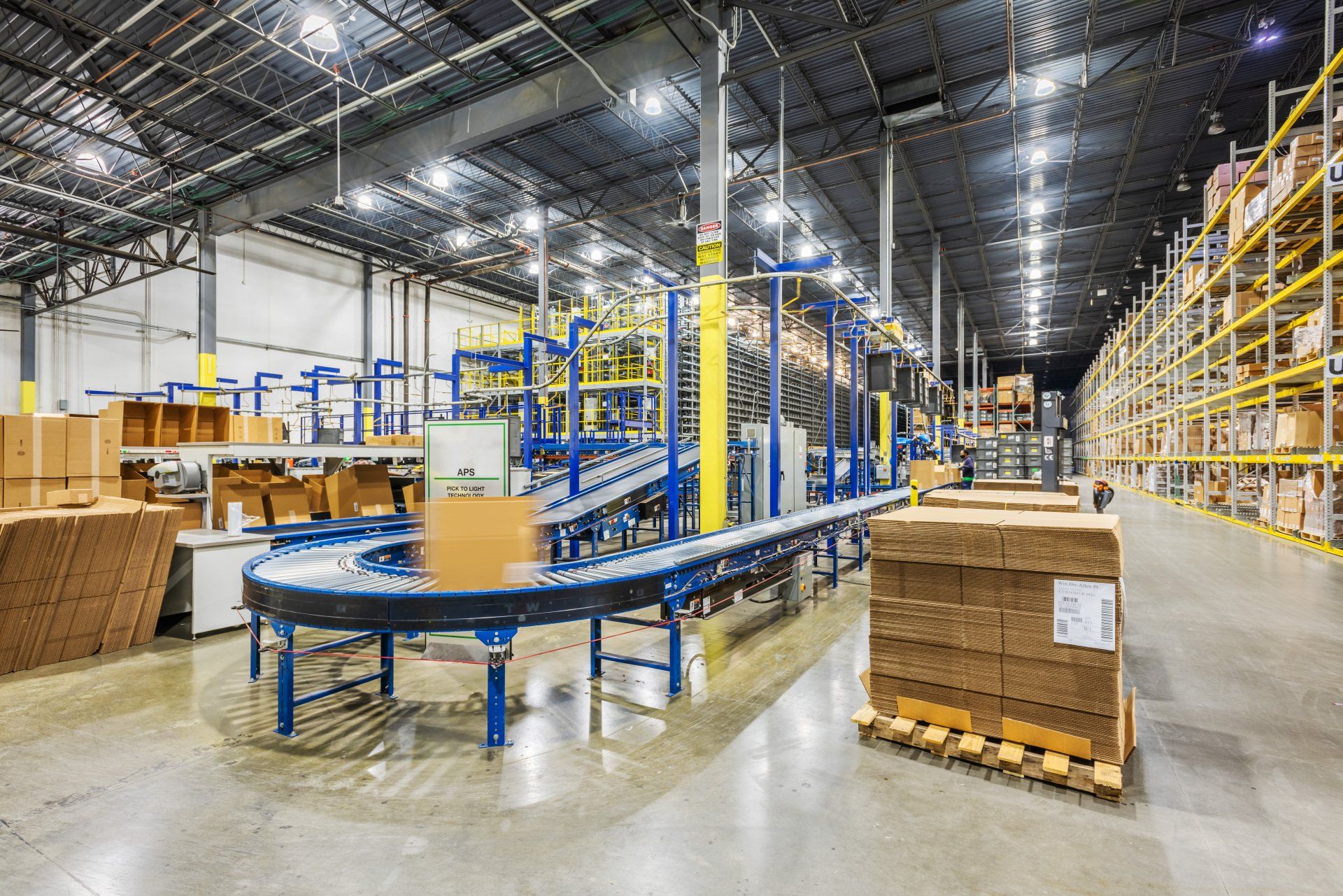 A large warehouse filled with lots of boxes and pallets.