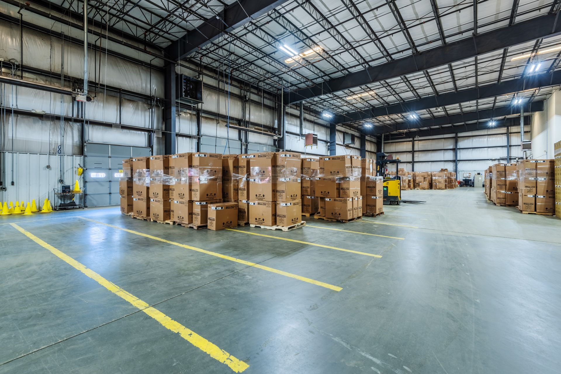 A large warehouse filled with lots of boxes and pallets.