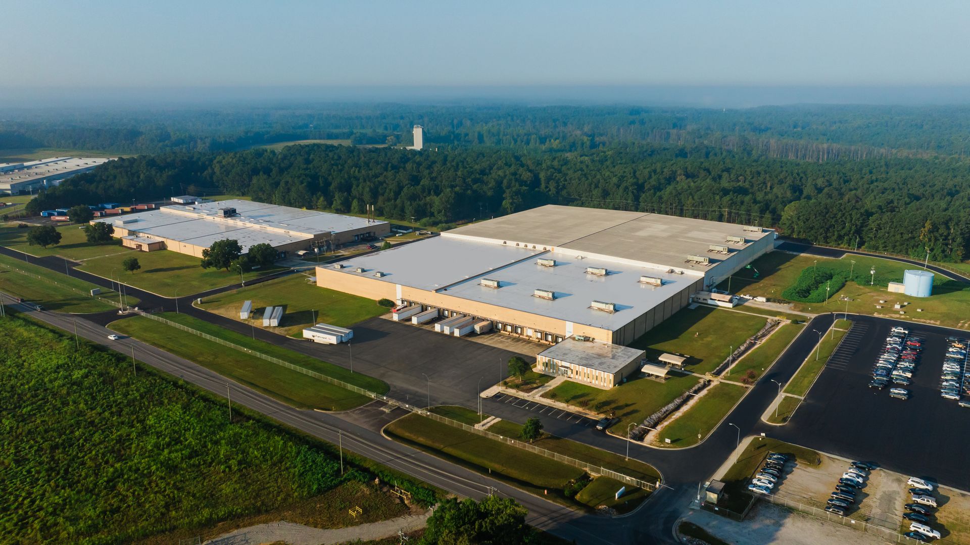 An aerial view of a large industrial area with lots of buildings and trees.