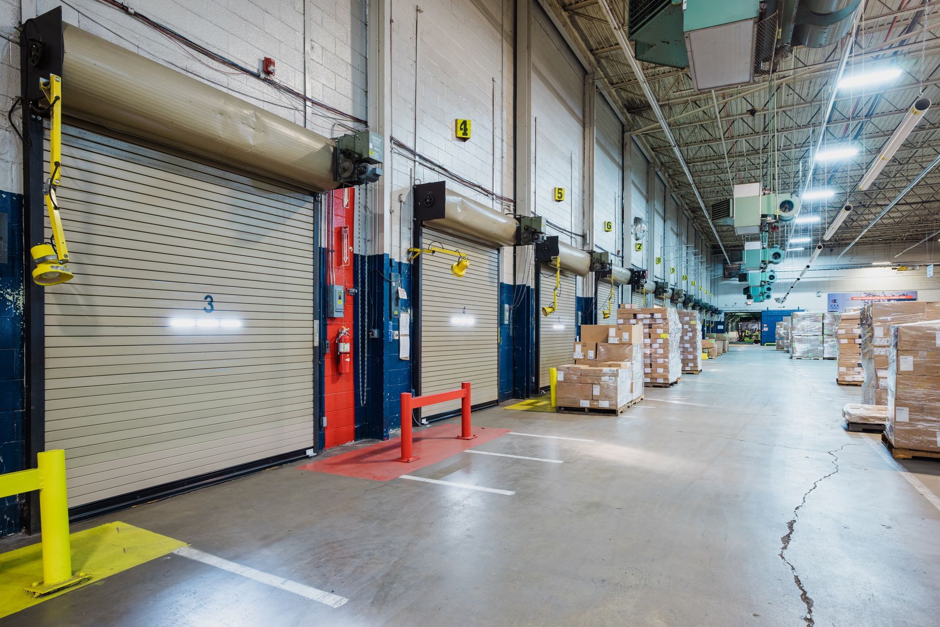 A large warehouse filled with lots of boxes and doors.