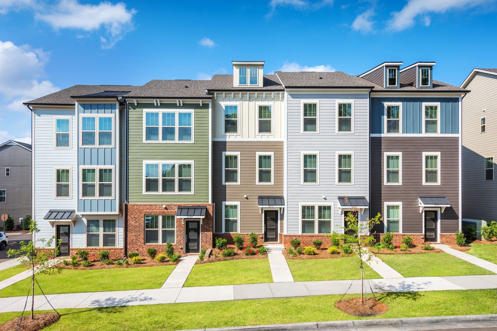 A row of apartment buildings with a lot of windows on a sunny day.