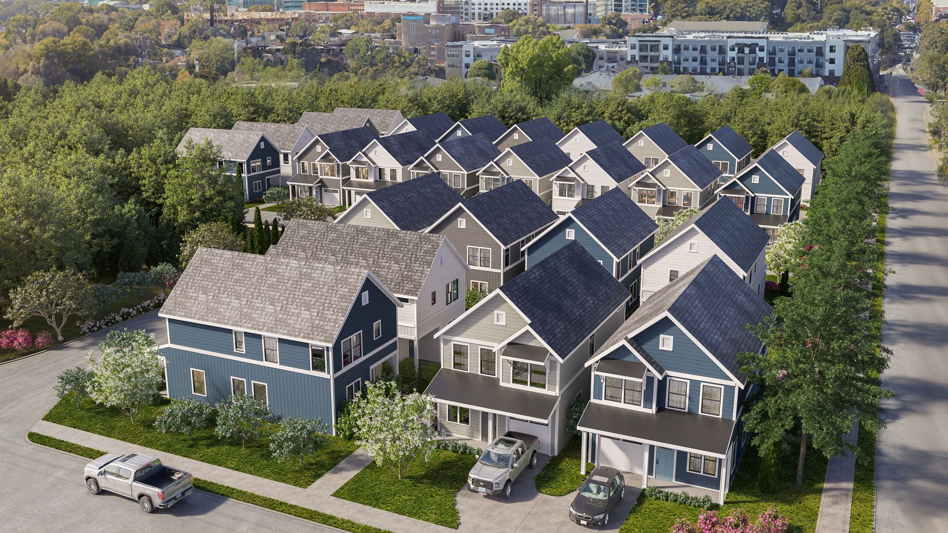 An aerial view of a row of houses with cars parked in front of them.