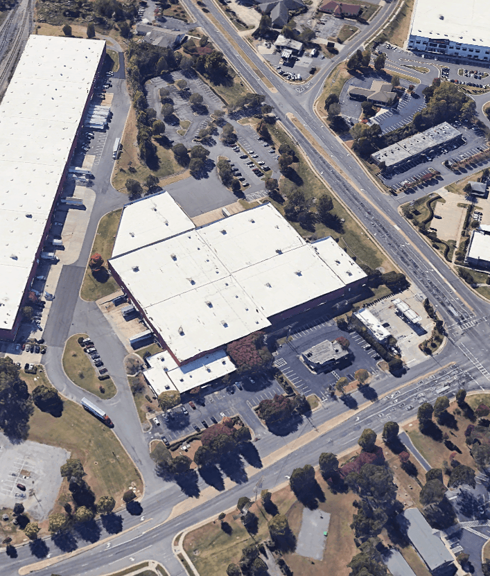An aerial view of a warehouse in a residential area