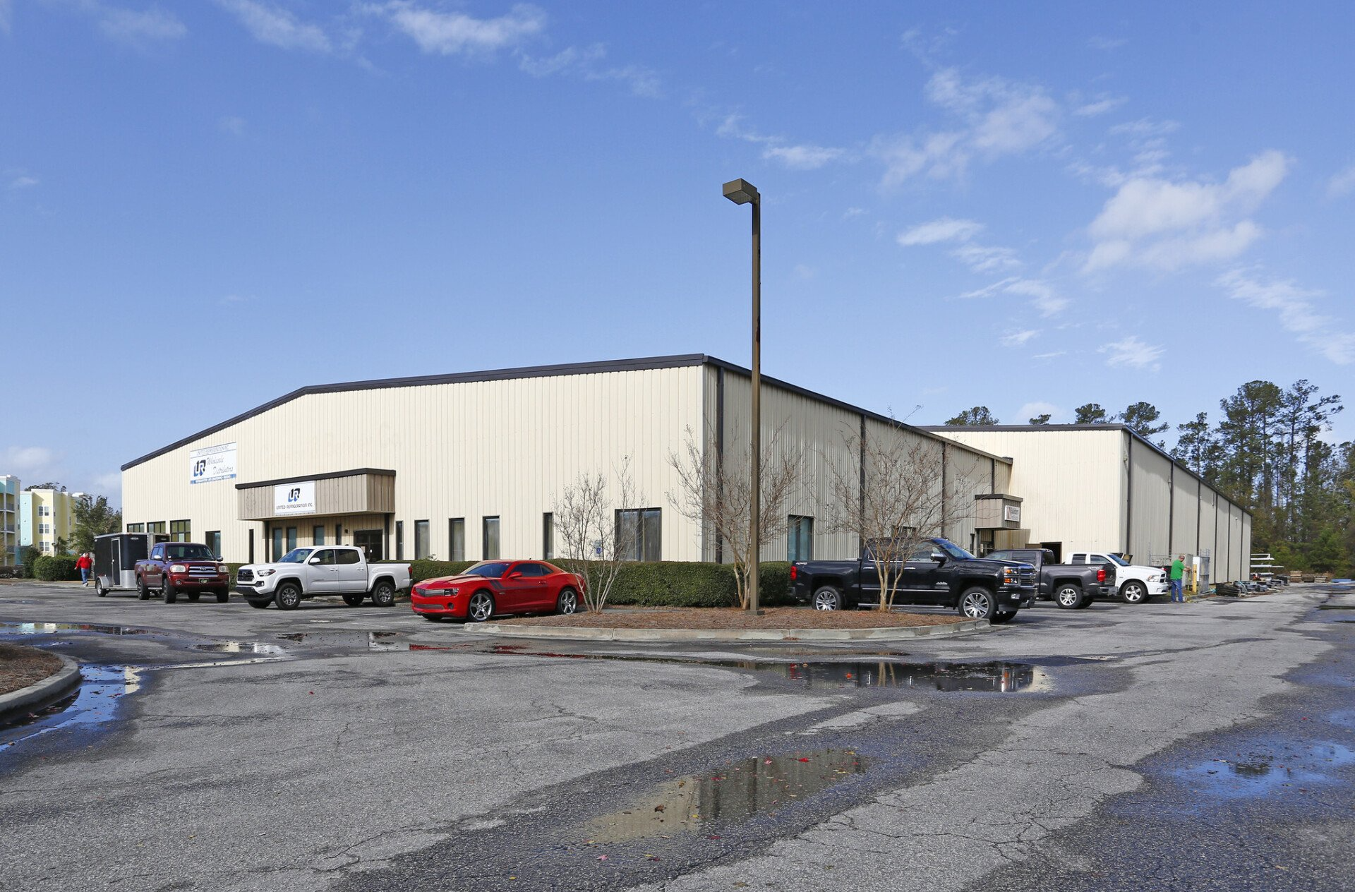 A large building with a lot of cars parked in front of it