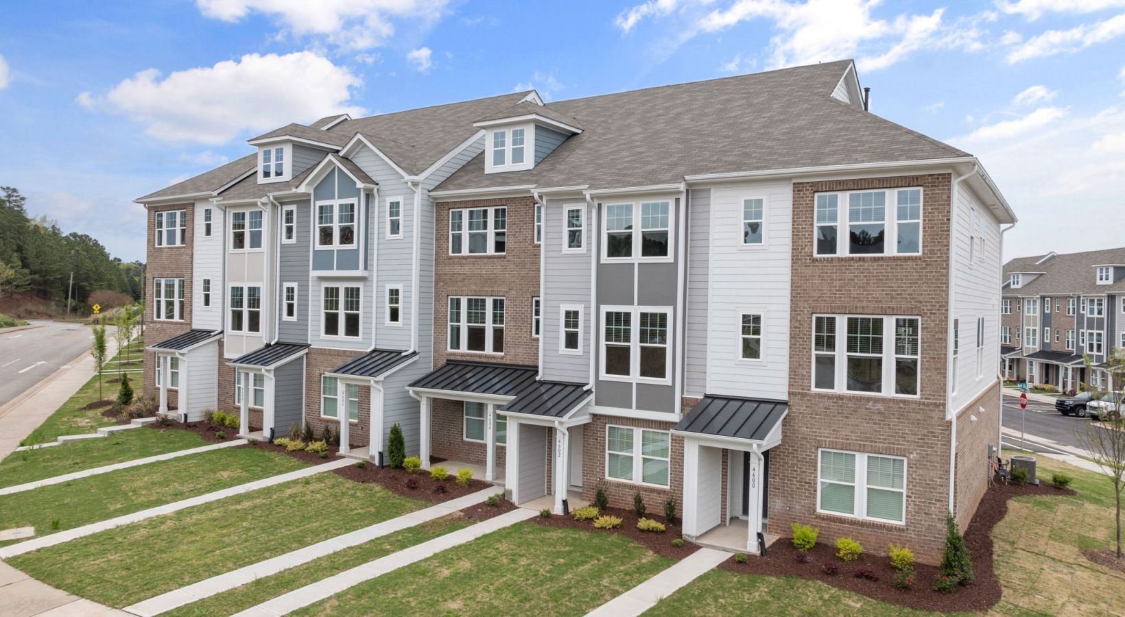 A row of brick apartment buildings with a lot of windows.