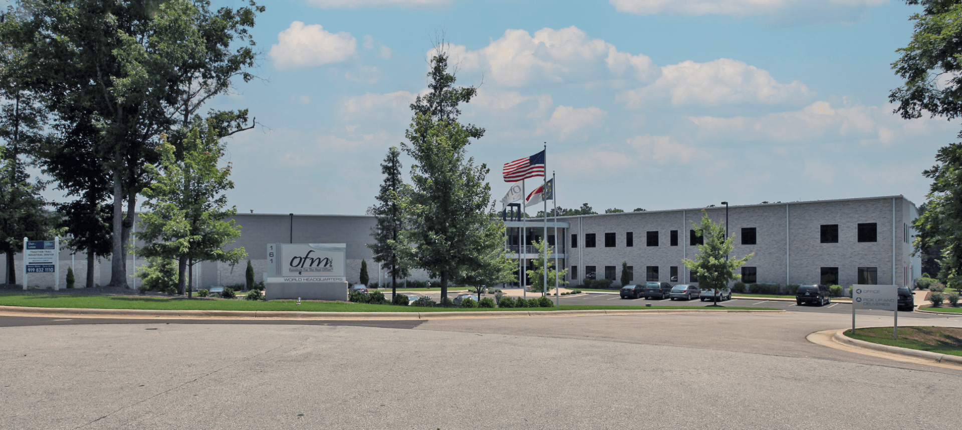 A large gray building with a sign that says ' office ' on it