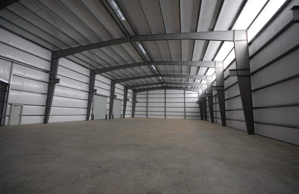 A large empty warehouse with a concrete floor