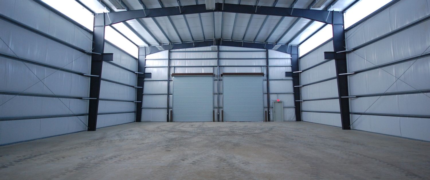 A large empty warehouse with a concrete floor