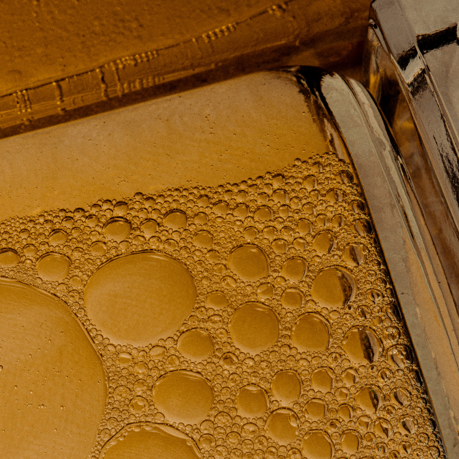 Close up of body oil in glass bottle