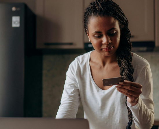 Orange t-shirt, tote bag, book, and mug with customizable brand text in teal.