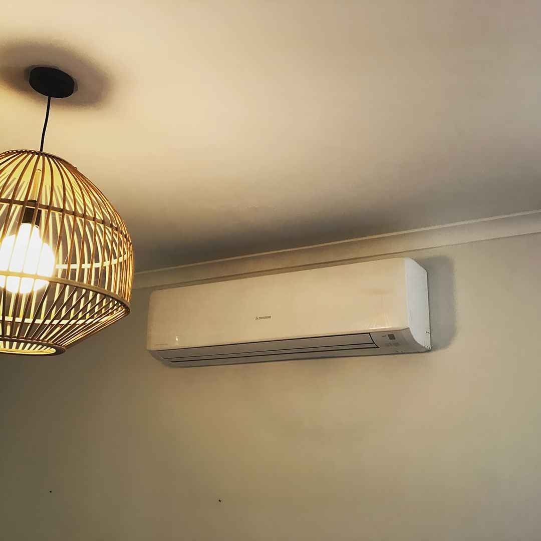 A Room With A Ceiling Light And A Wall Mounted Air Conditioner — Priest Airconditioning in Ashmont, NSW