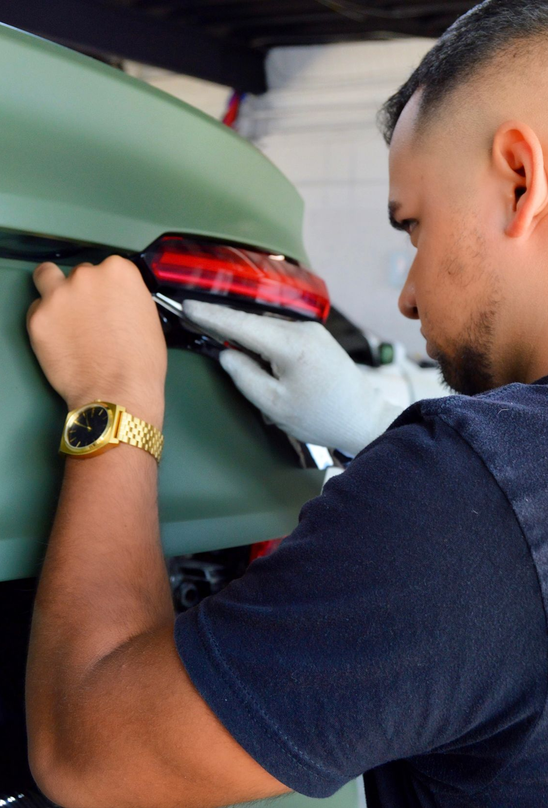Dark gray Toyota Camry parked outside on a sunny day.