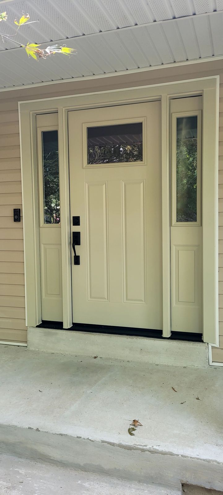 A white front door with a stained glass window