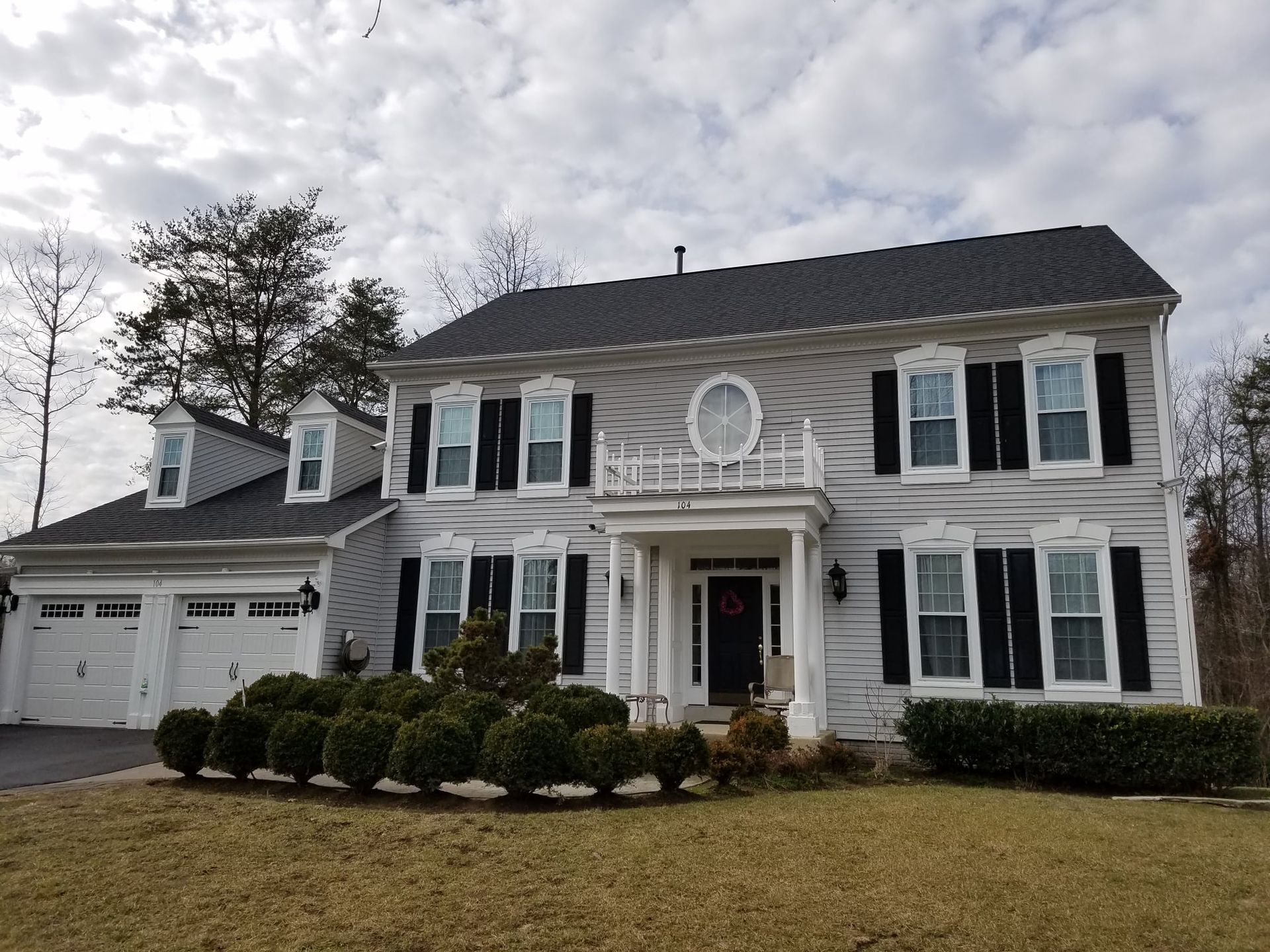 A large white house with black shutters on the windows