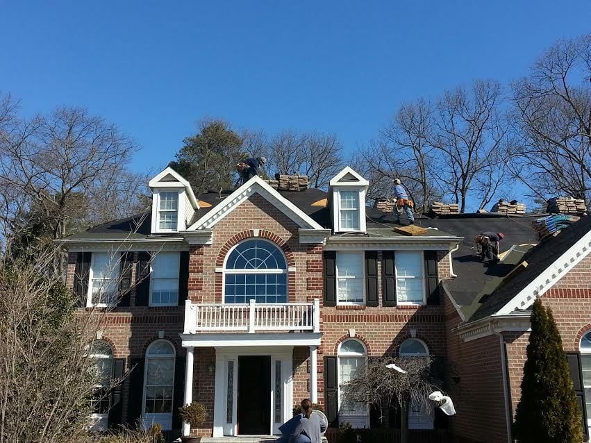 a large brick house with a balcony is being remodeled