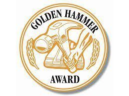 a golden hammer award logo with a hammer and wheat .