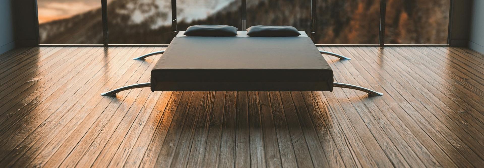 Hardwood Flooring under a modern style bed with windows looking out into the mountains