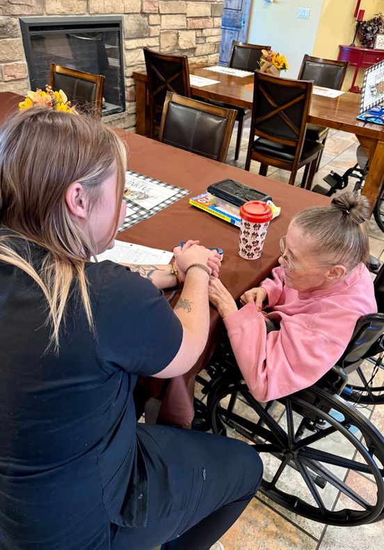 Lobby with stone fireplace, leather sofa, and ornate light fixtures; warm tones and rustic decor.