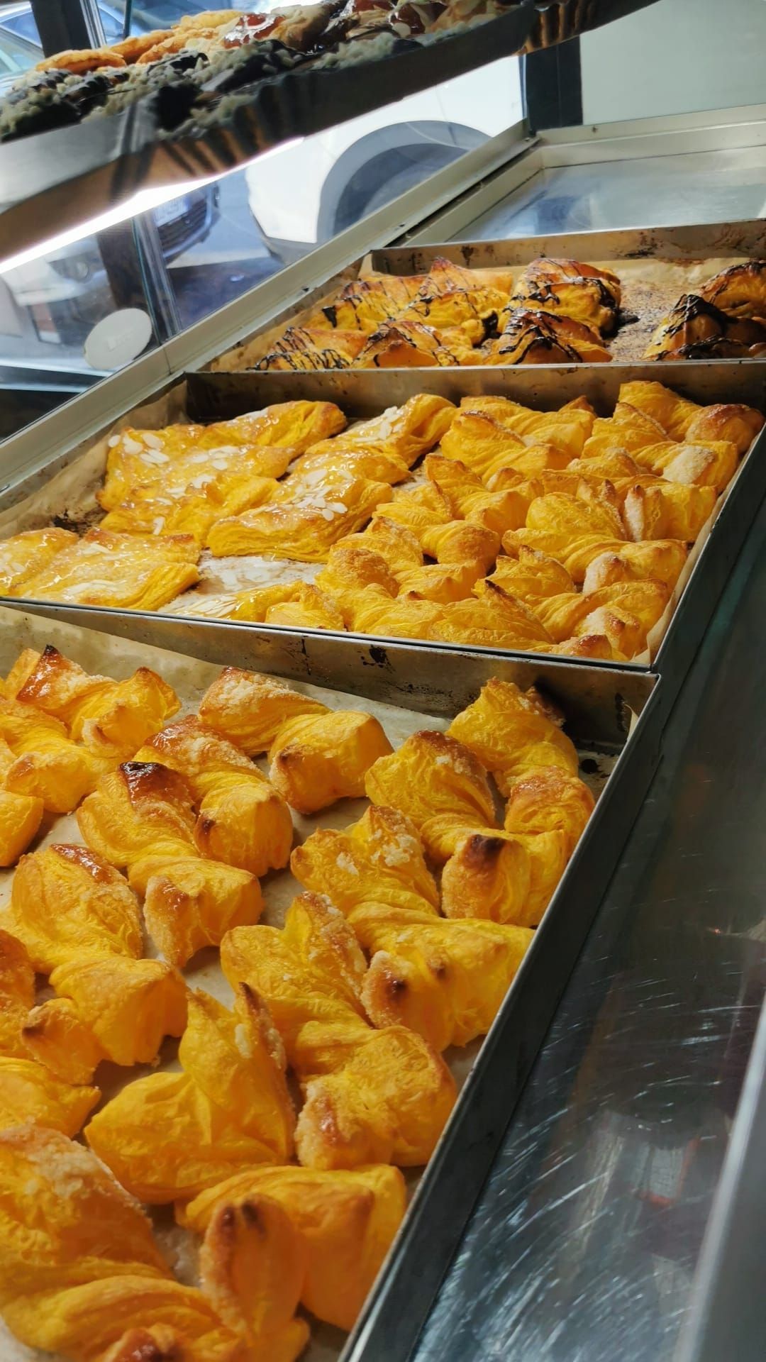 Una vetrina piena di dolciumi vari in una panetteria.