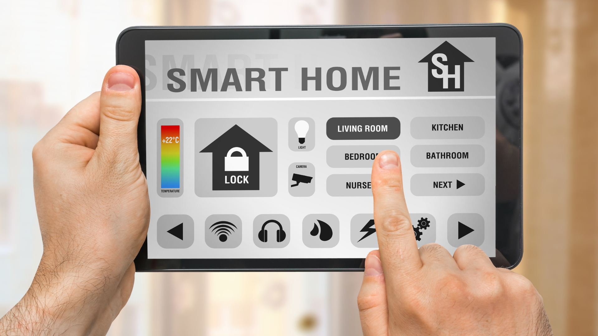 Person using a tablet to control a smart home interface, indoors. Features icons for security, lighting, and other home functions.