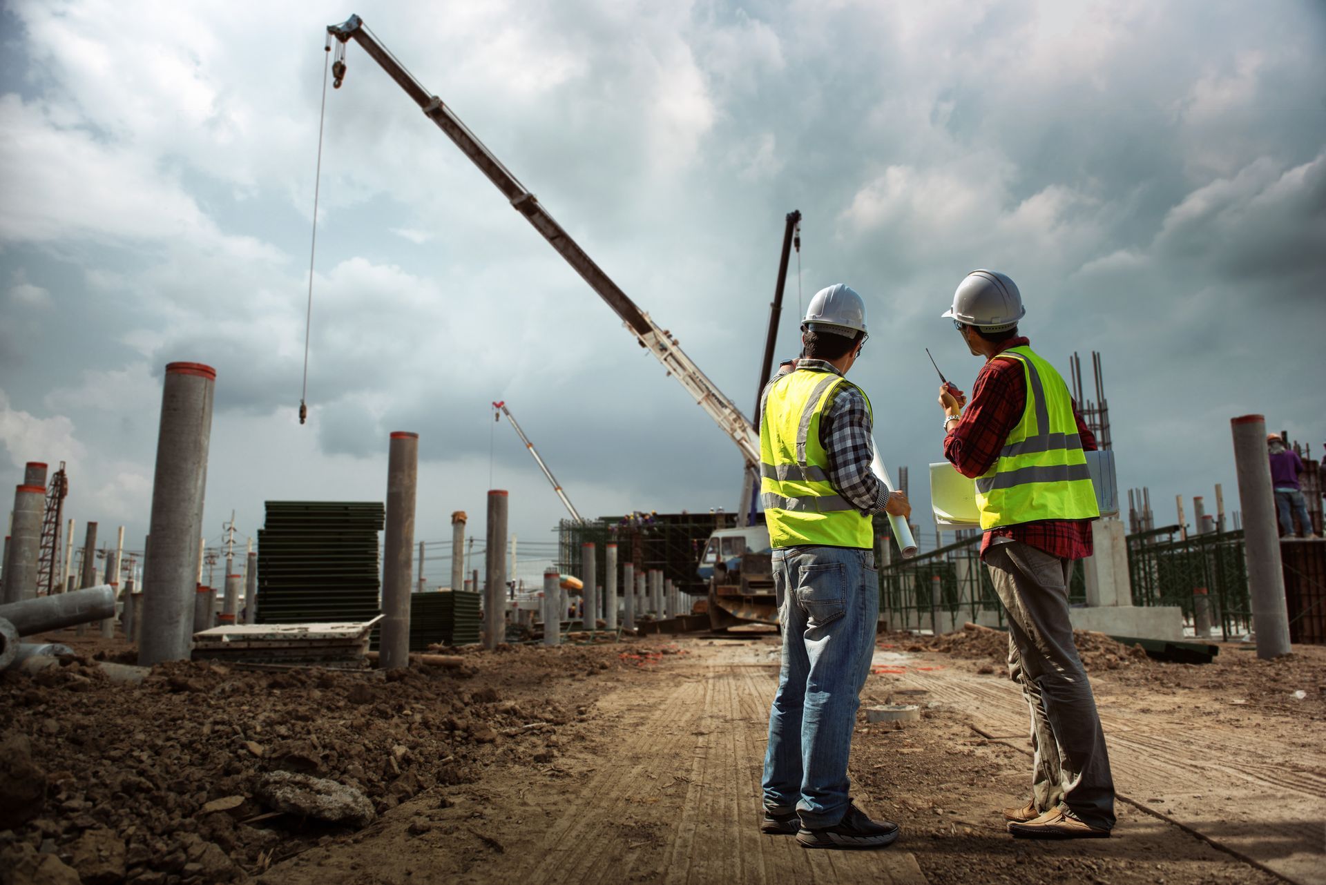Two Construction Workers Are Standing On A Construction Site — Riverton, UT — Great Basin Staffing LLC