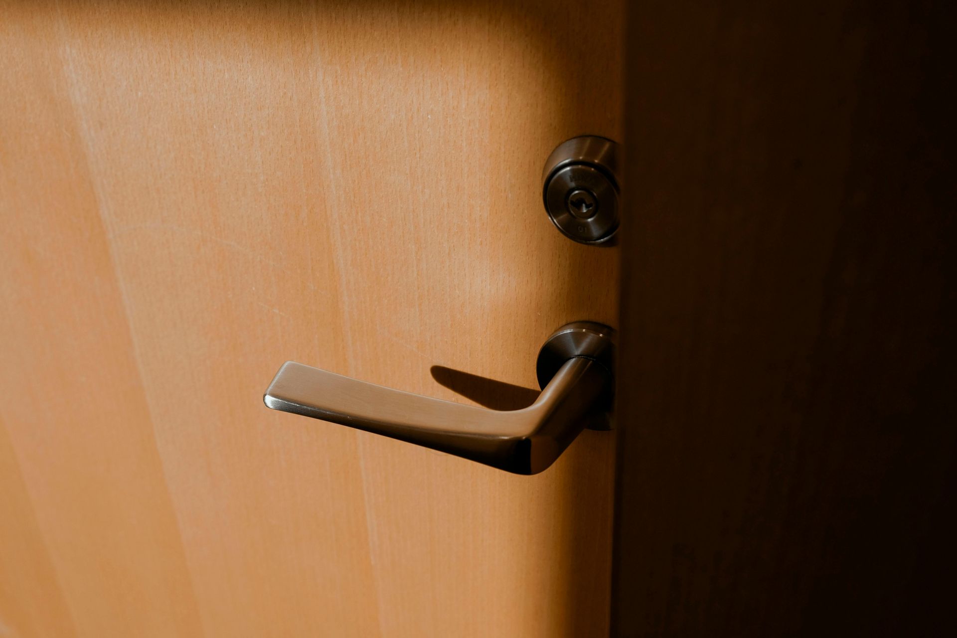 A close up of a door handle on a white door