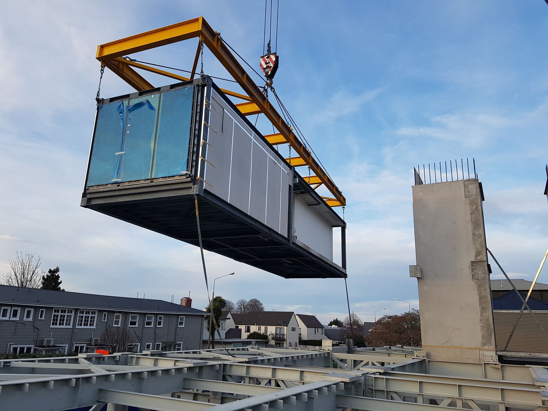 A large container is being lifted into the air by a crane.