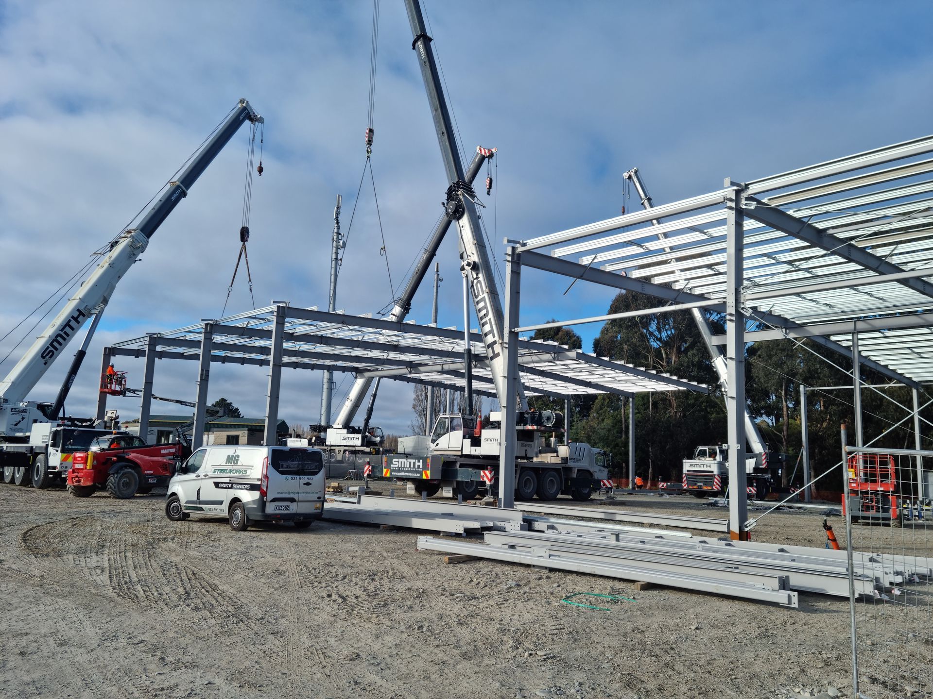 A large building is being built with a lot of cranes.