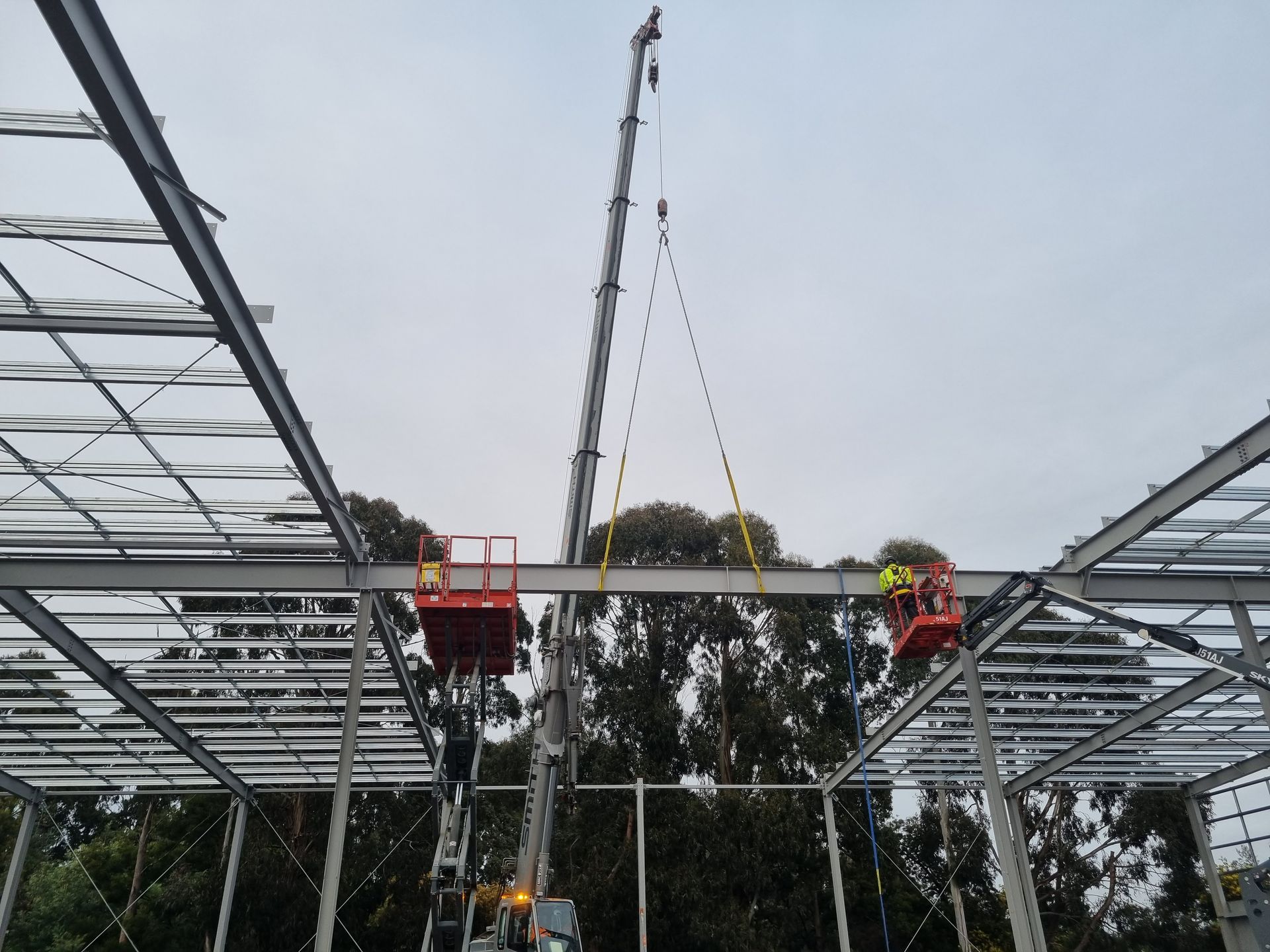 A crane is being used to lift a metal structure