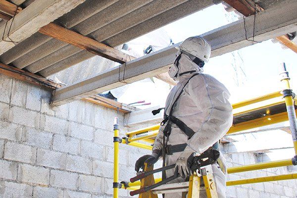 man in coveralls looking for asbestos