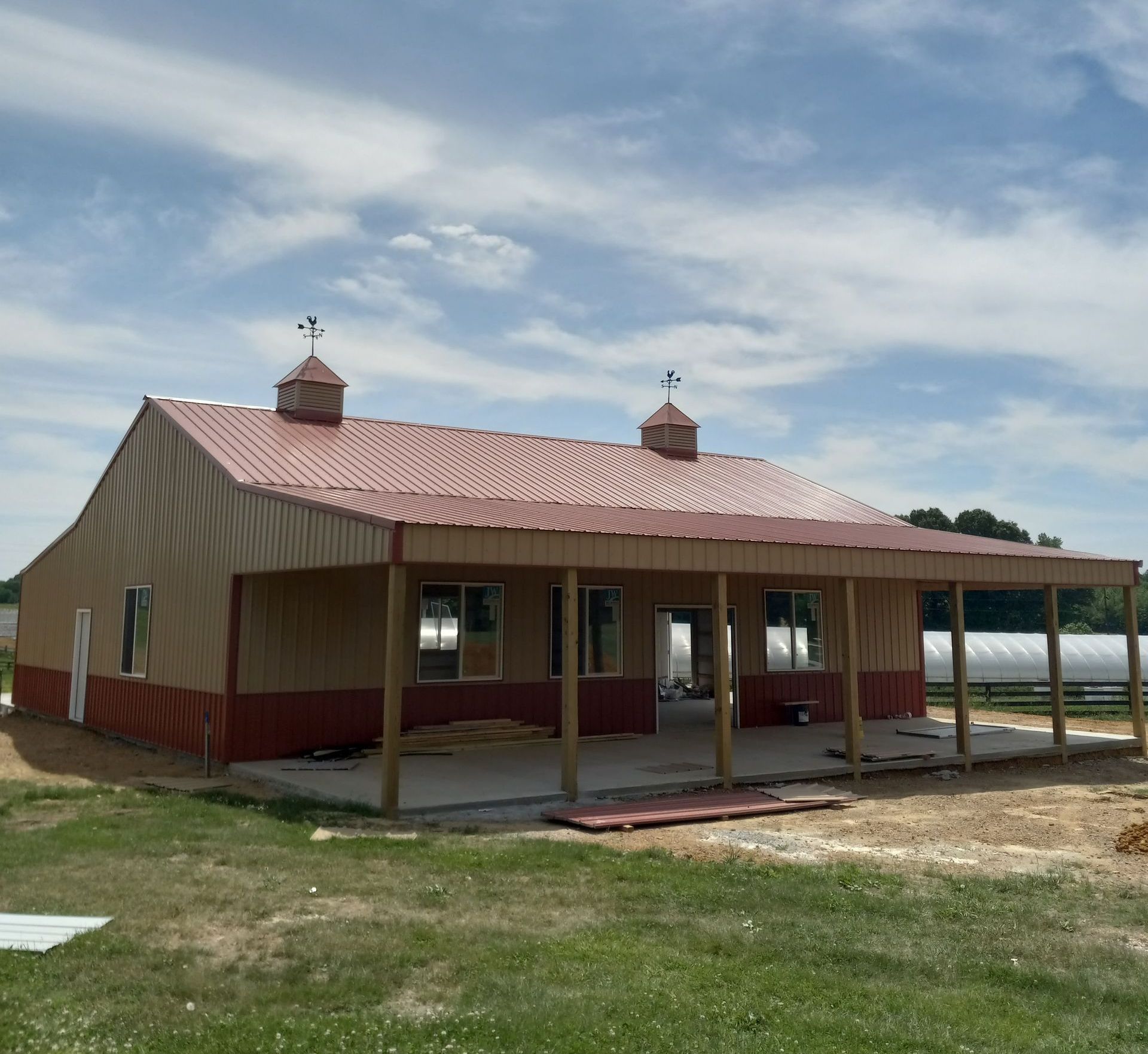 A small house with a red roof and a porch