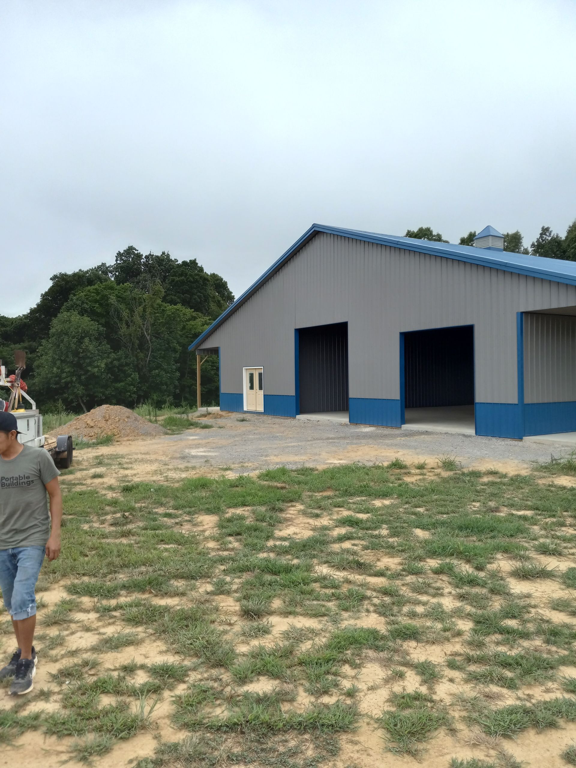 A man is walking in front of a large building