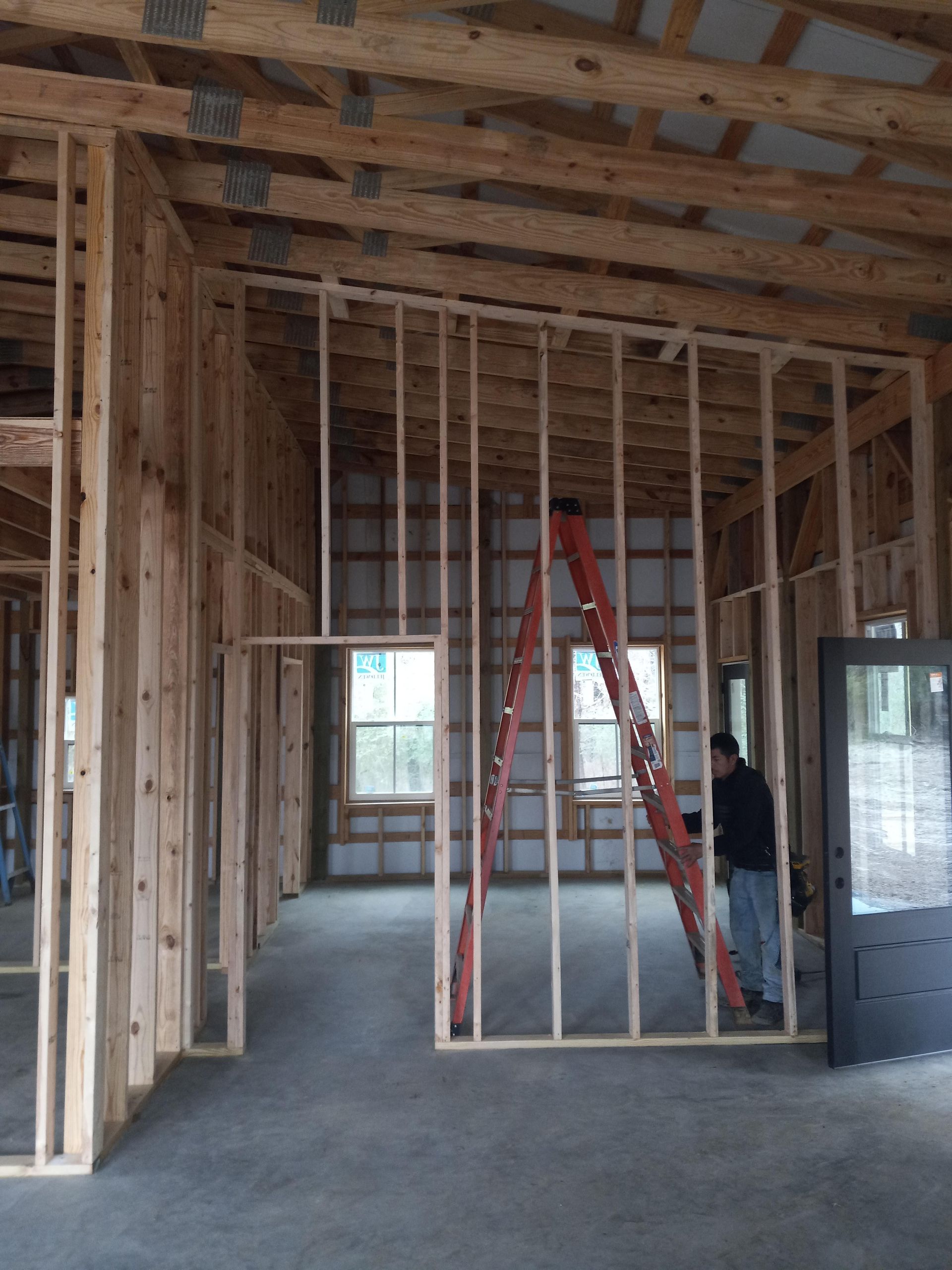 A man standing in a room with a ladder in it