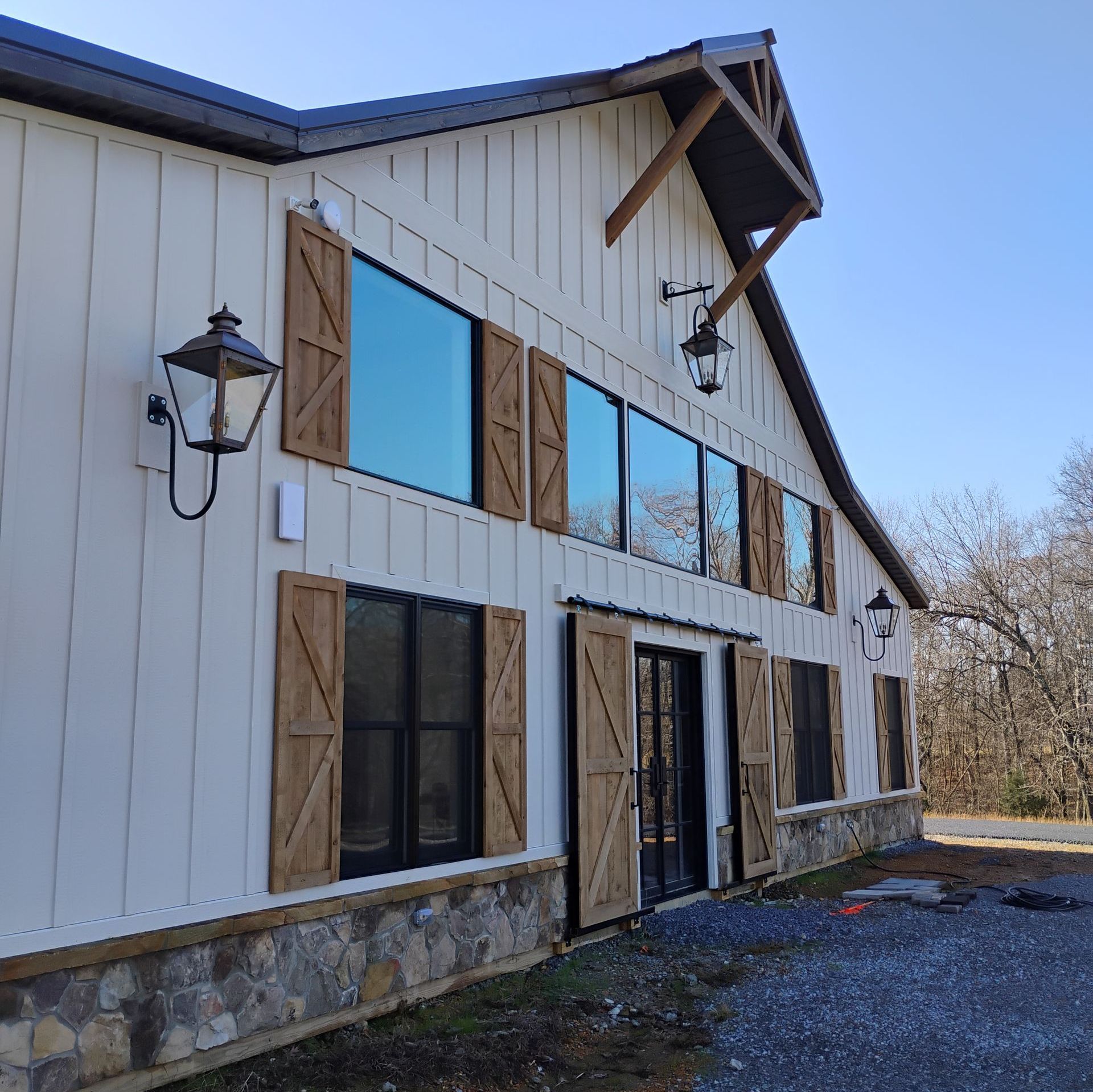 A large white building with wooden shutters on the windows
