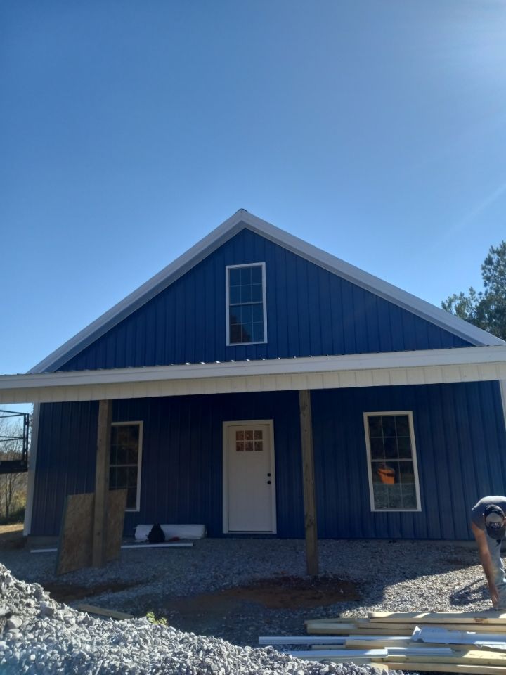 A blue house with a white door and windows