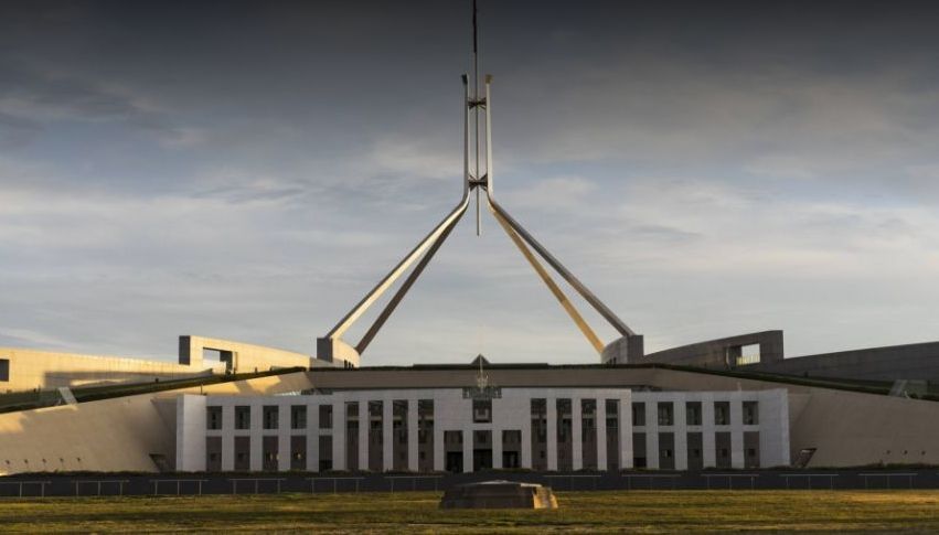 A bridge over a body of water with the opera house in the background