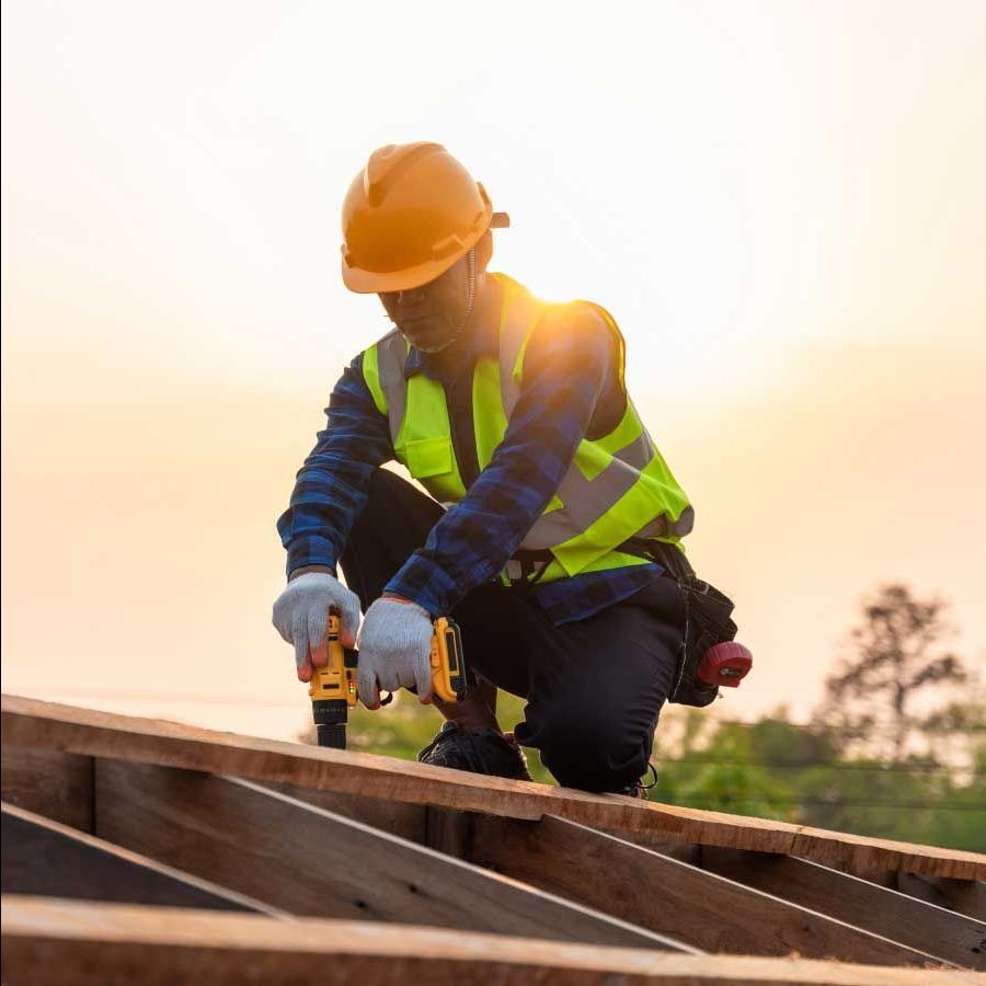 A construction worker is working on a wooden structure.