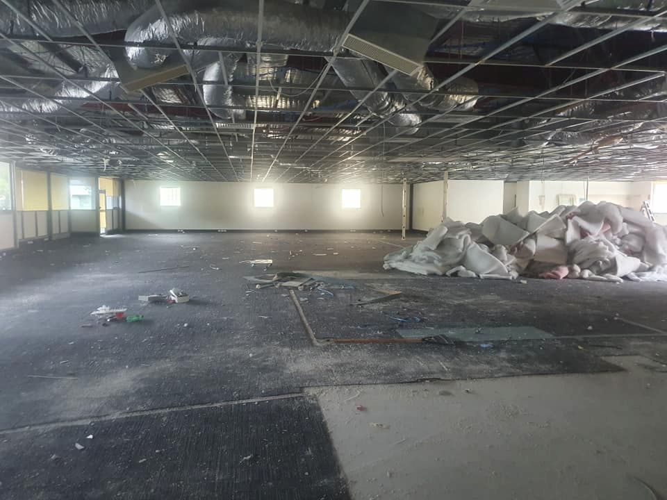 A Large Empty Room With a Pile of Trash on the Floor — D.J. Whatley & Son Pty Ltd in Beenleigh, QLD