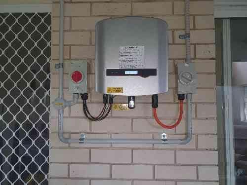 A Solar Panel is Mounted on a Brick Wall — D.J. Whatley & Son Pty Ltd in Ormeau Hills, QLD