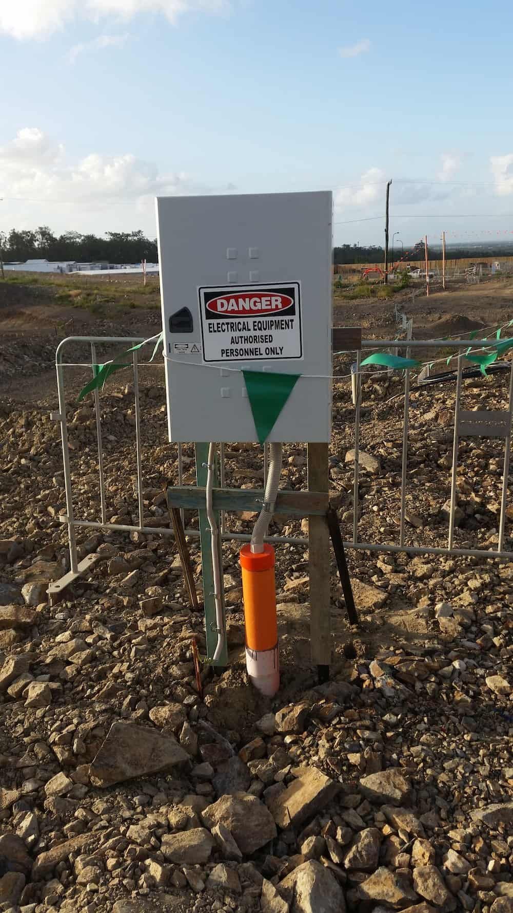 A Danger Sign is Sitting in the Middle of a Rocky Field — D.J. Whatley & Son Pty Ltd in Logan, QLD
