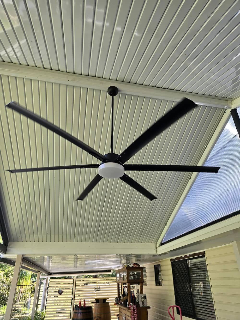 A Large Ceiling Fan is Hanging From the Ceiling of a House — D.J. Whatley & Son Pty Ltd in Ormeau Hills, QLD