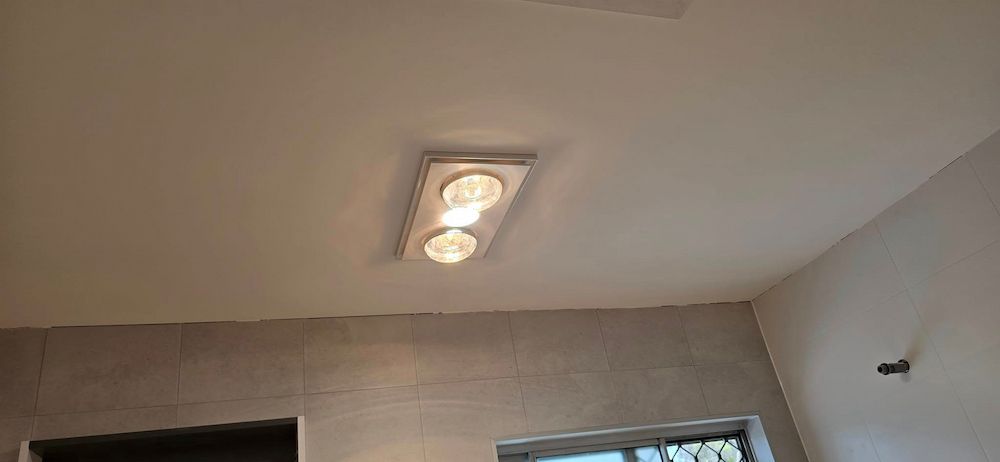 A Bathroom With a Ceiling Fan and Two Lights on It — D.J. Whatley & Son Pty Ltd in Ormeau Hills, QLD